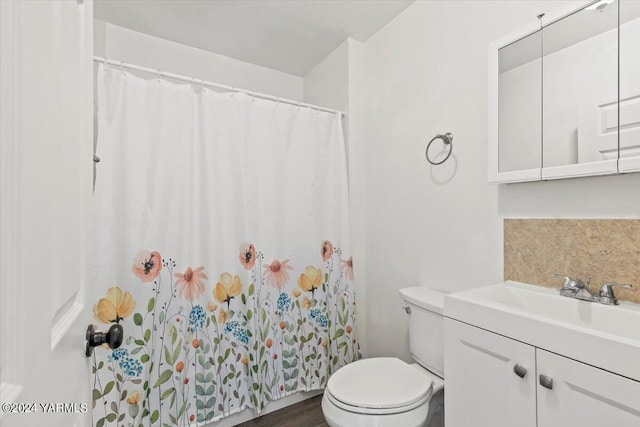 full bathroom with decorative backsplash, vanity, toilet, and wood finished floors