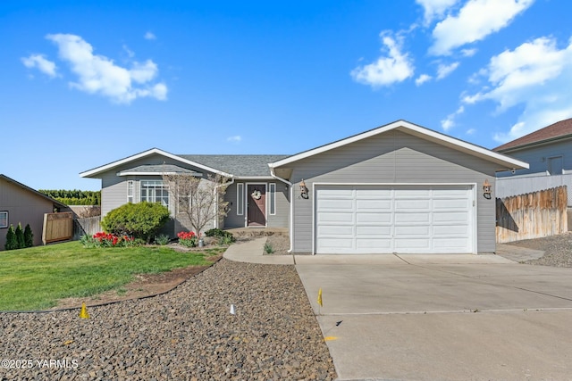 604 N 57th St, Yakima, WA 98901 - ranch-style house featuring concrete driveway, fence, a front yard, and a garage