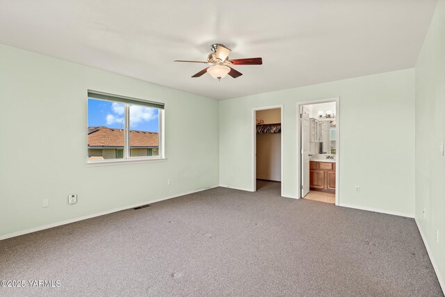 604 N 57th St, Yakima, WA 98901 - unfurnished bedroom featuring a spacious closet, connected bathroom, light colored carpet, baseboards, and visible vents