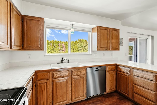 604 N 57th St, Yakima, WA 98901 - kitchen featuring tile counters, brown cabinetry, appliances with stainless steel finishes, and a sink