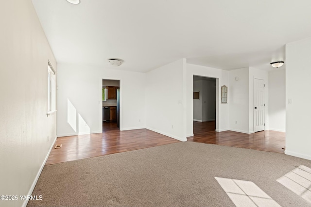 604 N 57th St, Yakima, WA 98901 - unfurnished living room with carpet floors, visible vents, and baseboards