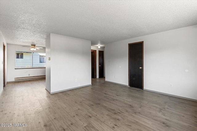 unfurnished living room with baseboards, ceiling fan, wood finished floors, a textured ceiling, and a baseboard radiator