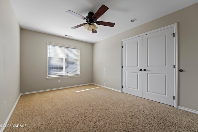 8704 Meadow Ln, Yakima, WA 98908 - unfurnished bedroom featuring carpet floors, baseboards, a closet, and ceiling fan