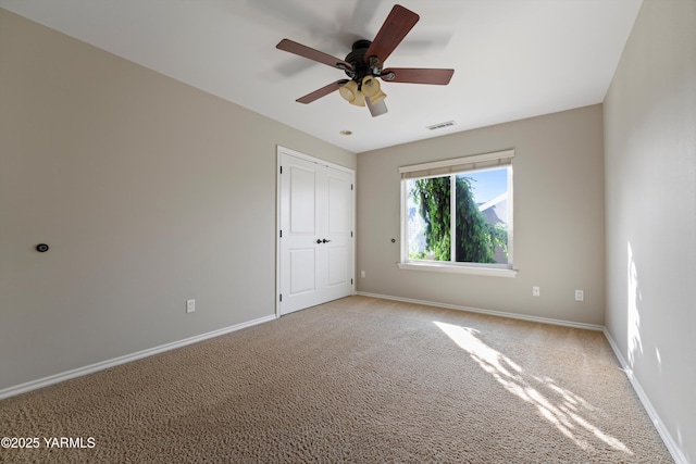 8704 Meadow Ln, Yakima, WA 98908 - unfurnished bedroom featuring baseboards, light carpet, ceiling fan, and a closet