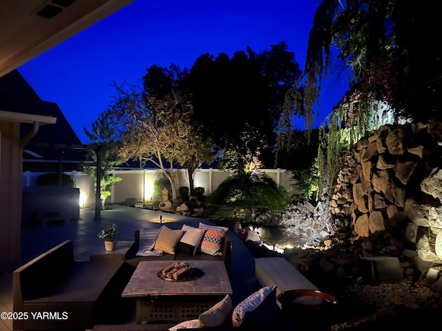 8704 Meadow Ln, Yakima, WA 98908 - patio at twilight with an outdoor fire pit and a fenced backyard