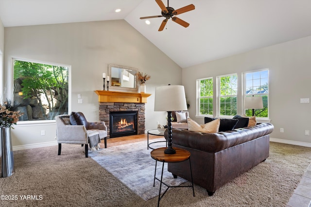 8704 Meadow Ln, Yakima, WA 98908 - carpeted living area featuring high vaulted ceiling, a stone fireplace, a ceiling fan, and baseboards