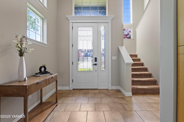8704 Meadow Ln, Yakima, WA 98908 - foyer entrance with baseboards, stairway, a high ceiling, and light tile patterned floors