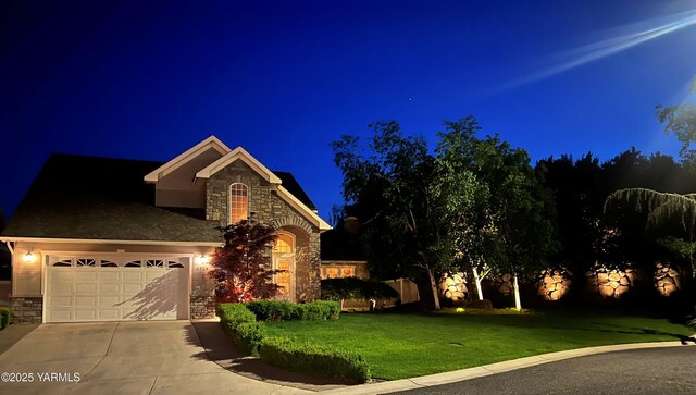 8704 Meadow Ln, Yakima, WA 98908 - view of front of property featuring stone siding, driveway, a lawn, and a garage