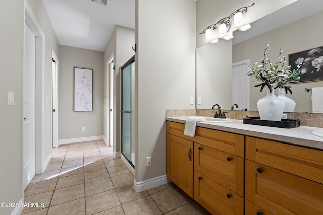 8704 Meadow Ln, Yakima, WA 98908 - bathroom with double vanity, tile patterned floors, a stall shower, and baseboards