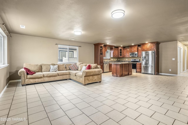 living room featuring light tile patterned flooring, visible vents, and baseboards