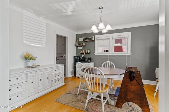 319 S 14th Ave, Yakima, WA 98902 - dining room featuring a chandelier and light wood-style floors