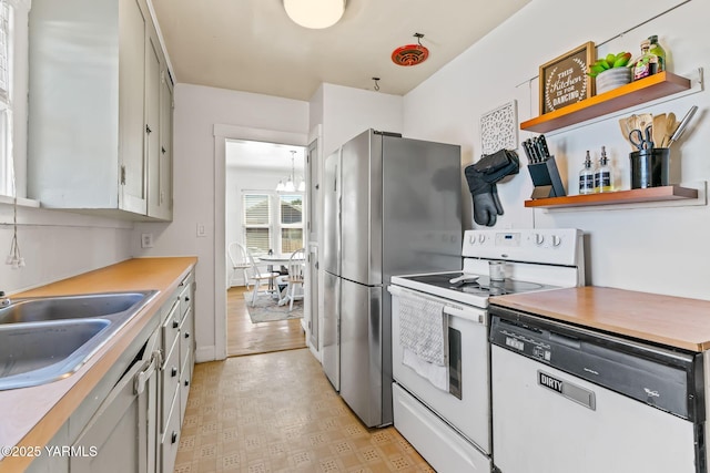 319 S 14th Ave, Yakima, WA 98902 - kitchen featuring white appliances, light countertops, open shelves, light flooring, and a sink