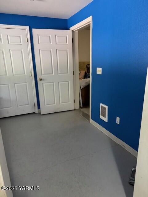 11705 Wide Hollow Rd, Yakima, WA 98908 - unfurnished bedroom featuring concrete flooring, baseboards, and a closet