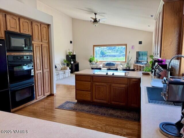11705 Wide Hollow Rd, Yakima, WA 98908 - kitchen featuring black appliances, dark wood-type flooring, light countertops, a ceiling fan, and vaulted ceiling