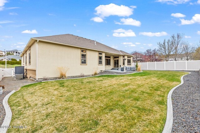 607 N 74th Ave, Yakima, WA 98908 - back of house with a gate, a patio area, stucco siding, a fenced backyard, and a lawn