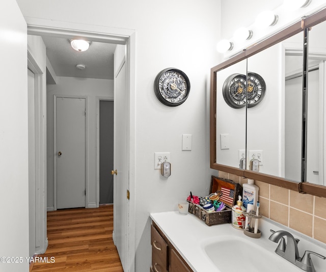 7610 Summitview Ave # 1, Yakima, WA 98908 - bathroom featuring vanity, wood finished floors, and backsplash