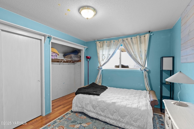 7610 Summitview Ave # 1, Yakima, WA 98908 - bedroom featuring wood finished floors, a closet, and a textured ceiling