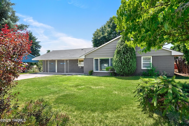 4504 W Lincoln Ave, Yakima, WA 98908 - rear view of house featuring a lawn, driveway, and a garage