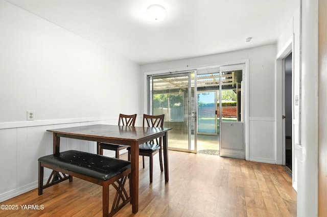 4504 W Lincoln Ave, Yakima, WA 98908 - dining room featuring wood finished floors, a wainscoted wall, and a decorative wall
