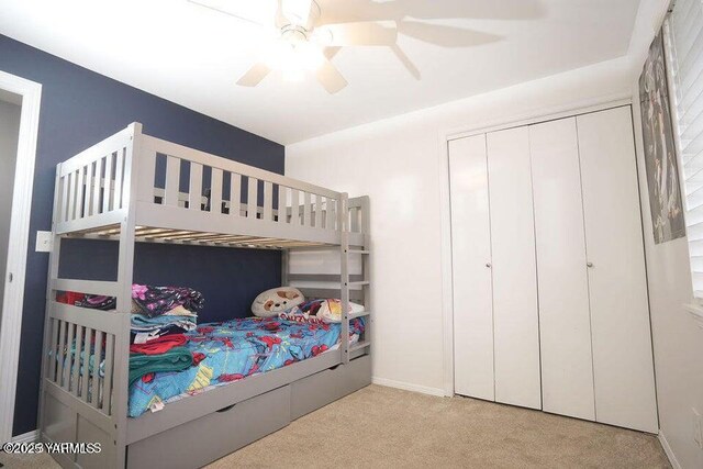6504 Terry Ave, Yakima, WA 98908 - bedroom with light carpet, ceiling fan, baseboards, and a closet