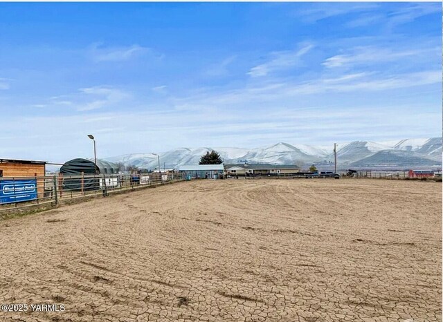 7773 N Wenas Rd, Selah, WA 98942 - view of yard featuring a mountain view, an enclosed horse arena, fence, and a rural view