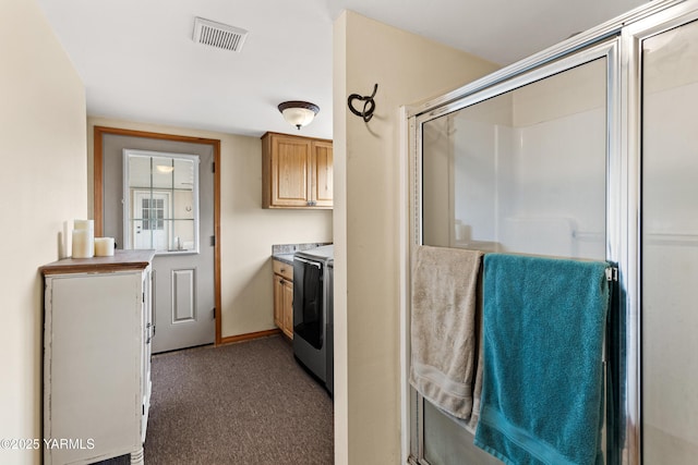 7773 N Wenas Rd, Selah, WA 98942 - laundry room with cabinet space, dark colored carpet, washer and clothes dryer, and baseboards