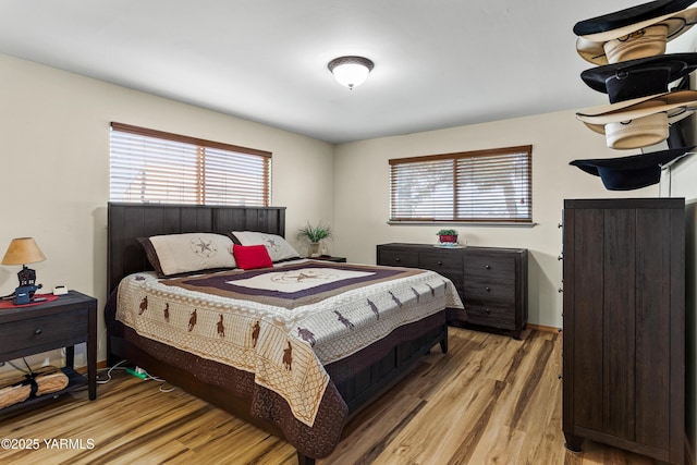 7773 N Wenas Rd, Selah, WA 98942 - bedroom featuring light wood-type flooring and multiple windows