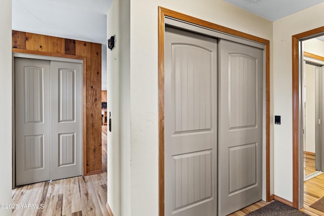 7773 N Wenas Rd, Selah, WA 98942 - corridor with light wood-style floors, baseboards, and wood walls
