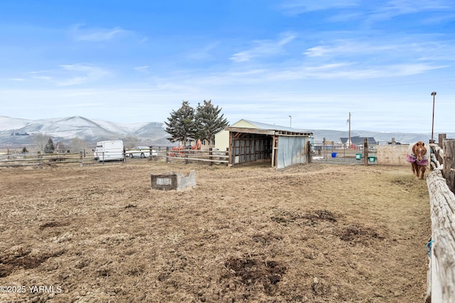 7773 N Wenas Rd, Selah, WA 98942 - view of yard featuring a mountain view, an exterior structure, an outbuilding, and fence