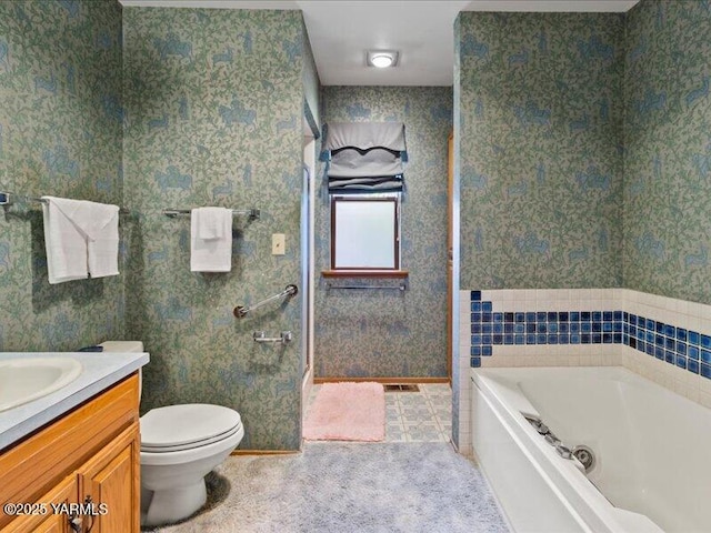 bathroom with wallpapered walls, toilet, a garden tub, and vanity
