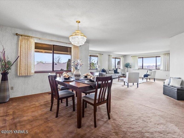 dining area featuring a chandelier, wallpapered walls, a textured ceiling, and carpet