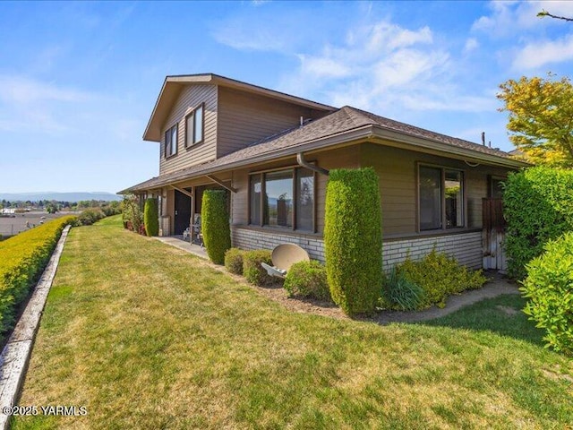 view of property exterior with a lawn