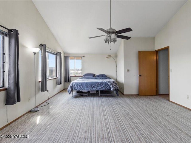 carpeted bedroom with baseboards, high vaulted ceiling, and a ceiling fan
