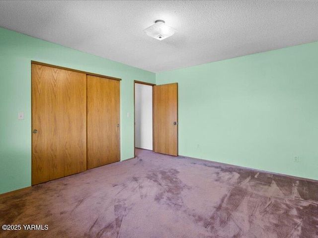 unfurnished bedroom with a closet and carpet flooring