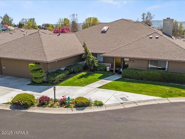 ranch-style house featuring a chimney, a garage, driveway, roof with shingles, and a front lawn