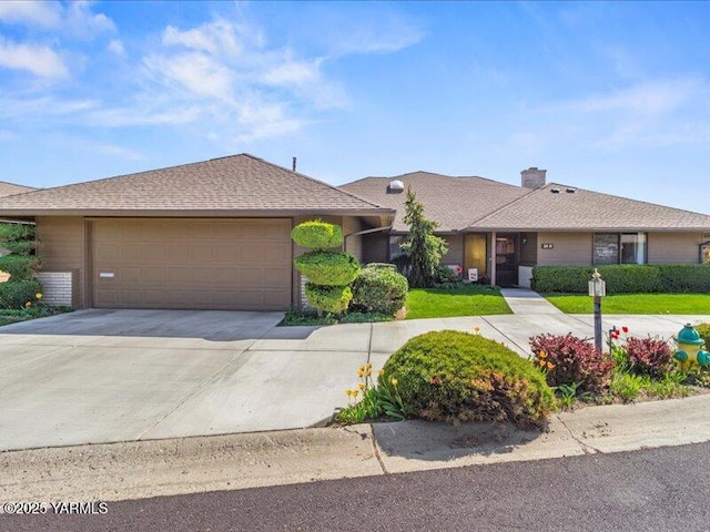 ranch-style house featuring driveway, an attached garage, and a chimney