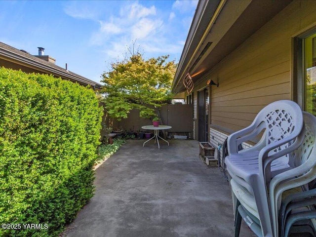 view of patio featuring fence