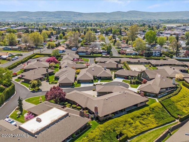 birds eye view of property with a mountain view and a residential view