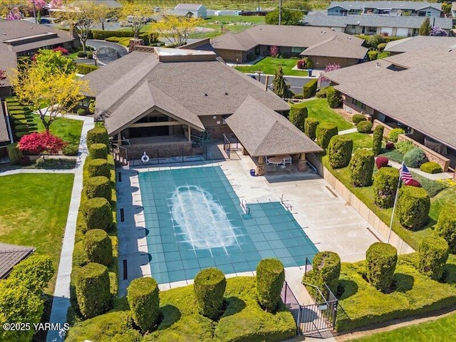 view of pool featuring fence, a gate, and a residential view