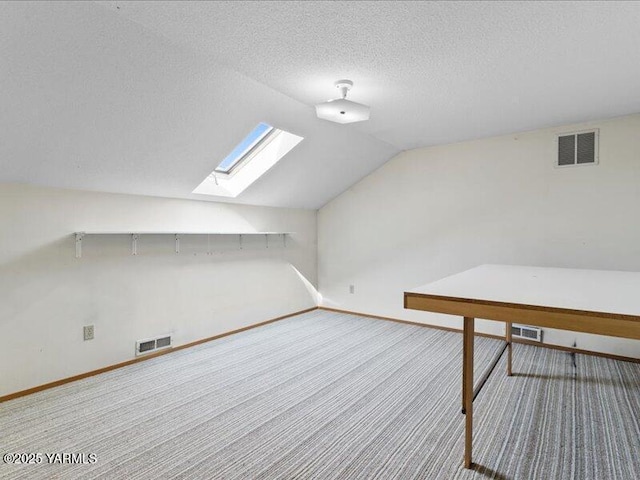 additional living space featuring carpet, visible vents, and baseboards