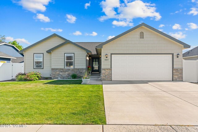 5610 Whitman St, Yakima, WA 98903 - ranch-style house with stone siding, concrete driveway, and a garage