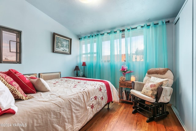 bedroom featuring vaulted ceiling and wood finished floors