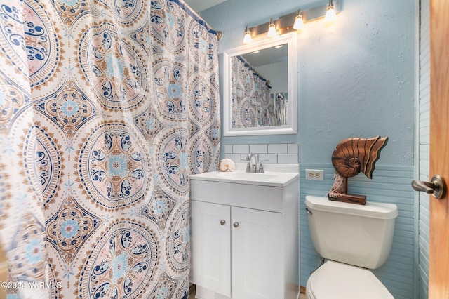full bath featuring vanity, backsplash, toilet, and tile walls