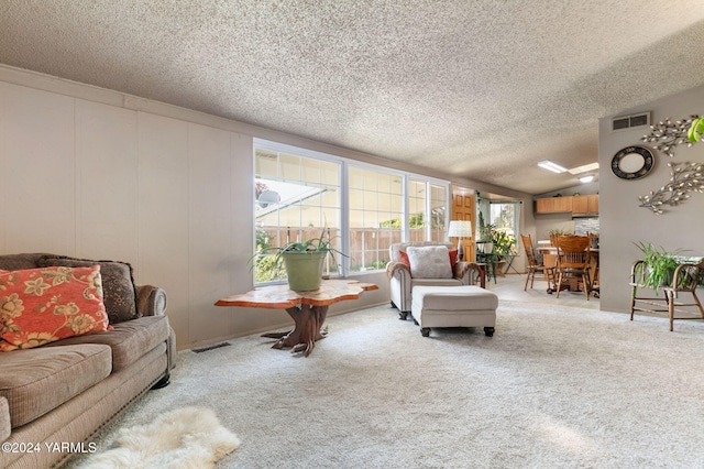 living room featuring carpet flooring, a textured ceiling, and visible vents