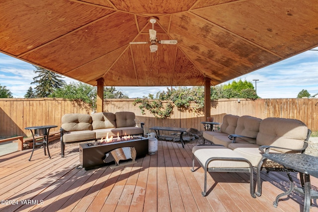 wooden terrace featuring a gazebo, a fenced backyard, and an outdoor living space with a fire pit