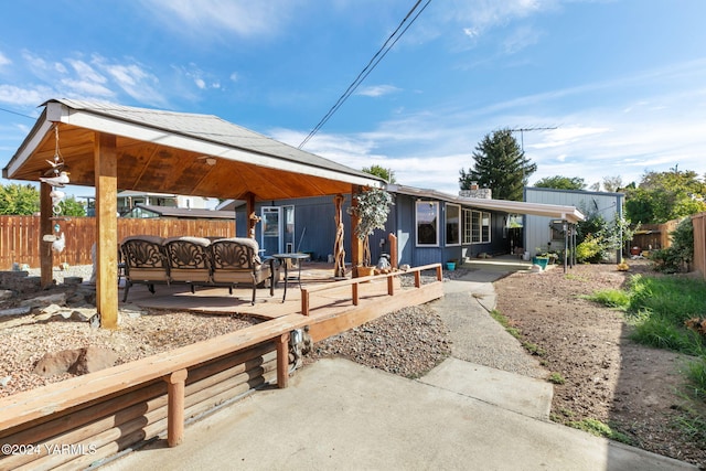 rear view of house with fence, a patio, and a gazebo