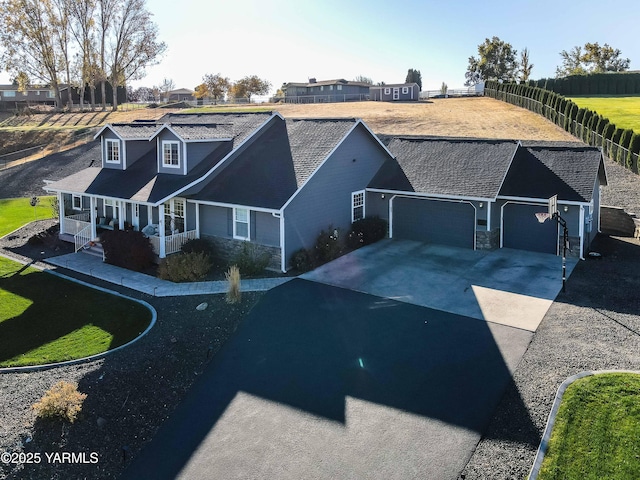 11300 Flintstone Rd, Yakima, WA 98908 - view of front facade with asphalt driveway, a garage, and stone siding