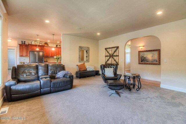 11300 Flintstone Rd, Yakima, WA 98908 - living room featuring light colored carpet, arched walkways, and recessed lighting