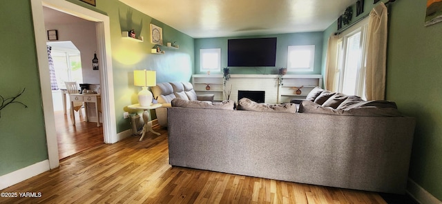 4511 Englewood Ave, Yakima, WA 98908 - living room featuring baseboards, wood finished floors, and a fireplace