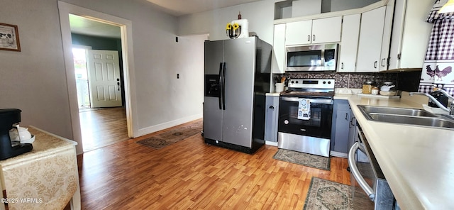 4511 Englewood Ave, Yakima, WA 98908 - kitchen featuring stainless steel appliances, a sink, light wood-style flooring, and light countertops